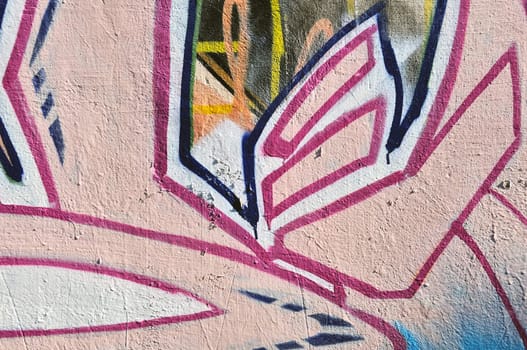 Weathered wall covered with abstract graffiti. Urban street art background.