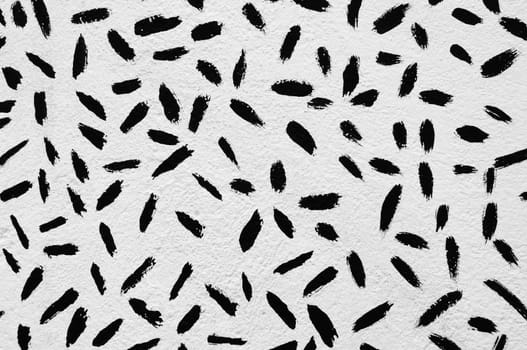 Abstract paint strokes pattern on textured wall. Black and white.