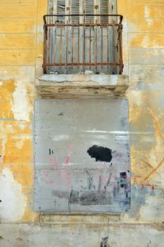 Bricked up window and weathered wall of an abandoned building.