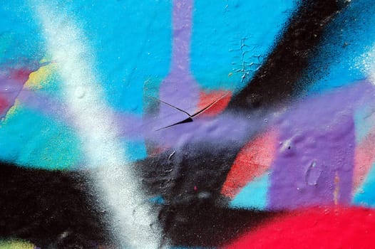 Wall covered with abstract chipped paint graffiti. Urban street art background.