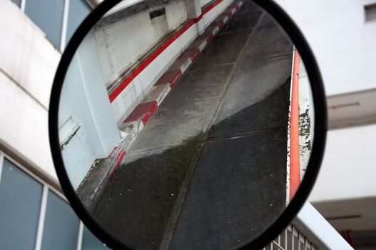 Parking driveway mirrored on convex curved mirror.