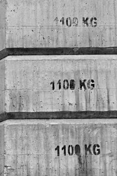 Concrete blocks used as counter weight in construction. Black and white.
