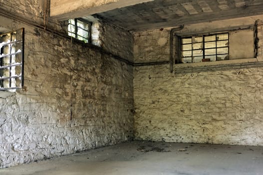 Empty room broken windows and textured white wall. Abandoned factory interior.
