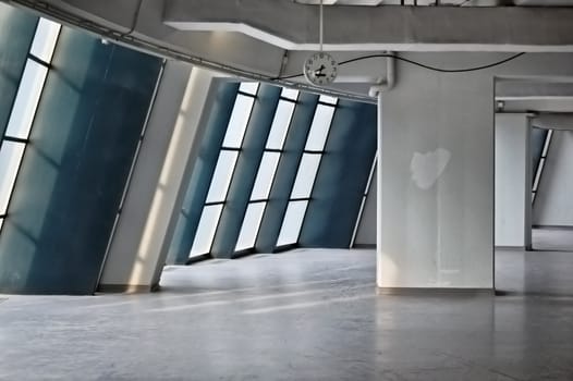 Empty industrial hallway and clock. Modern architecture.