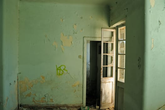 Empty room and textured peeling paint wall. Abandoned house interior.