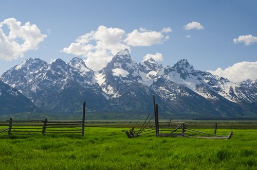 Old fence and the Teton Mountain Range in early summer, Grand Teton National Park, Teton County, Wyoming, USA