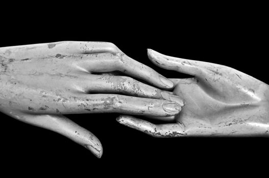 Weathered hands of plastic mannequin doll. Black and white.