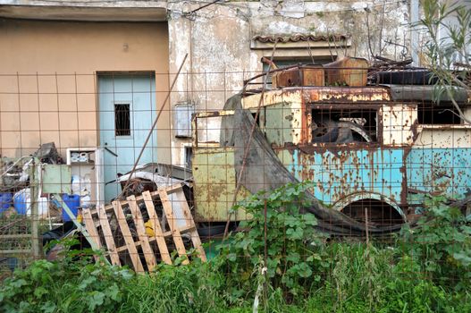 Abandoned house junkyard and rusty vintage car.