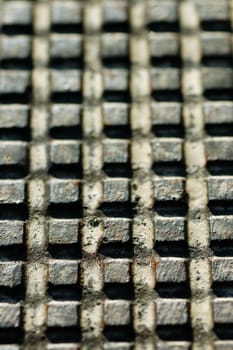 Rusty industrial metal surface with squares pattern. Selective focus.