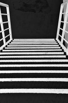 Metal stairs on a ferry boat. Black and white.
