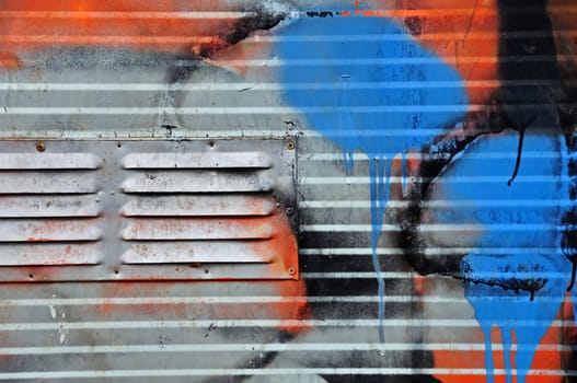 Detail of metal surface covered with messy graffiti.