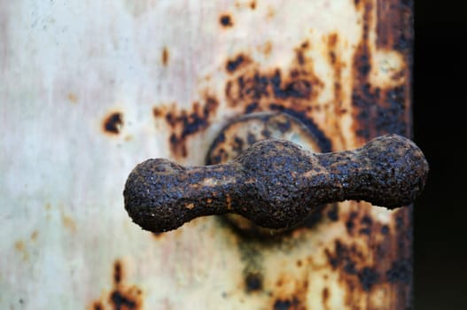 Rusty industrial metal door knob macro. Selective focus.