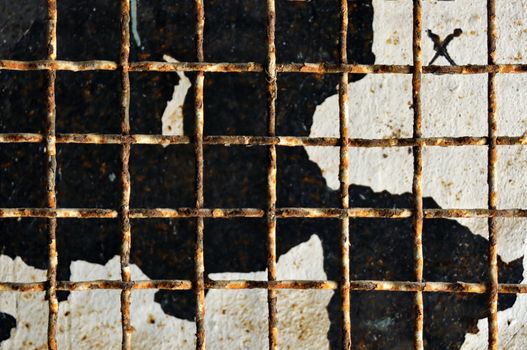 Rusty door metalwork and chipped paint. Abstract industrial texture.