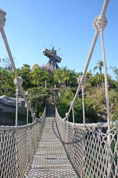 A long bridge and a boat on a rock