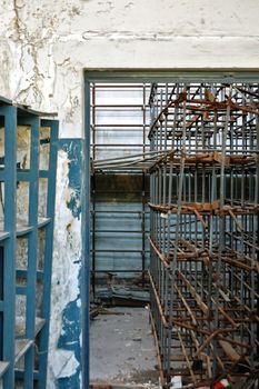 Storage room with empty industrial shelves in abandoned factory.