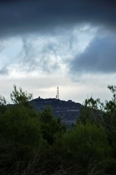 Overcast winter sky over a small hill.