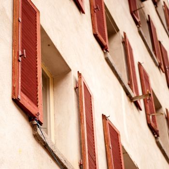 a wall with a lot of red windows