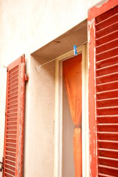 an old and dirty window with shutters