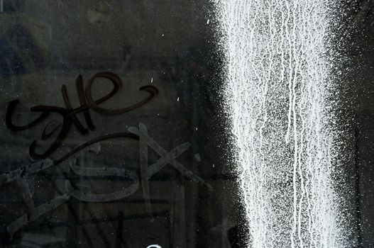 White paint splashed over a dusty glass surface. Grunge texture.