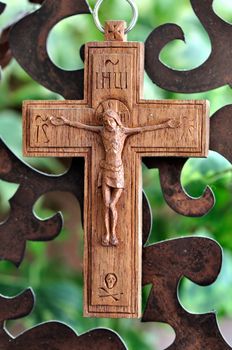 Wooden crucifix and rusty metal pattern background.