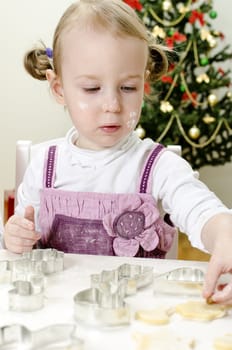 little cute girl making Christmas cookies