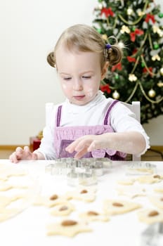 little cute girl making Christmas cookies