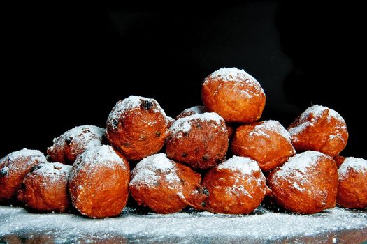 a lot of dutch food, named 'oliebollen' with suger