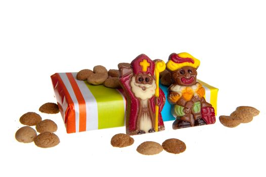 Sweet candy -gingernuts- with a present and a chocolate 'sint' and 'piet', c elebrating a dutch holiday called 'sinterklaas'