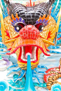 Colorful dragon face is blowing water.