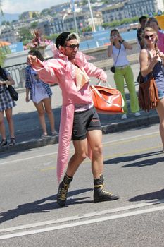 Man dressed up as a woman with a pink coat, a bag and dancing in the street at the Gay Pride parade 2011, Geneva, Switzerland