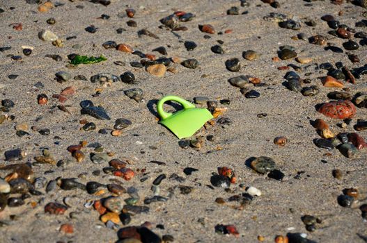 shard in the sand on the seashore, a broken coffee cup