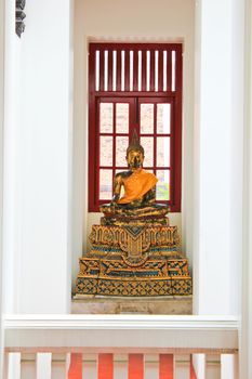 Golden Buddha in peaceful library