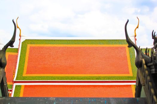 Thai colorful temple roof with black temple roof as foreground