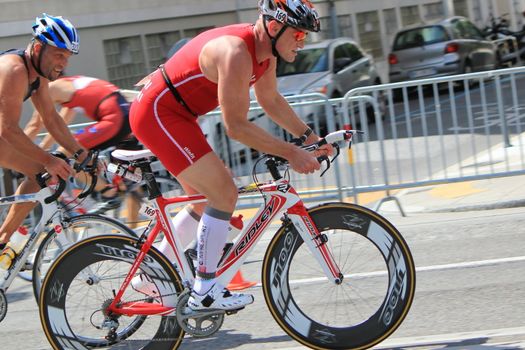 Male cyclist wearing red helmet and clothes at the International Triathlon 2011, Geneva, Switzerland