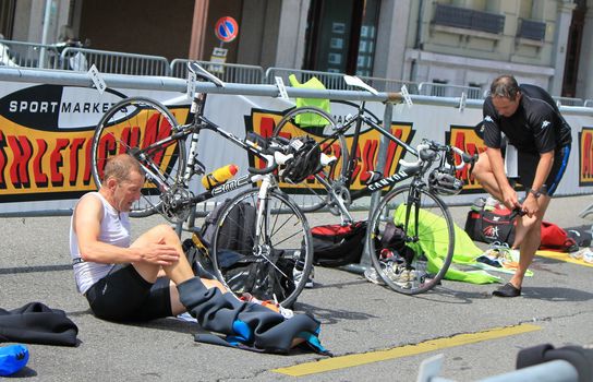 Cyclists changing clothes to go biking at the International Triathlon 2011, Geneva, Switzerland