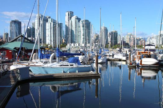 A Vancouver BC skyline at False creek and a marina Canada.