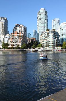 Vancouver BC skyline at False creek high rises and skyscrapers along the waterway.