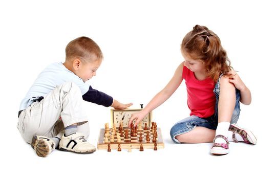 Children playing chess on the white background
