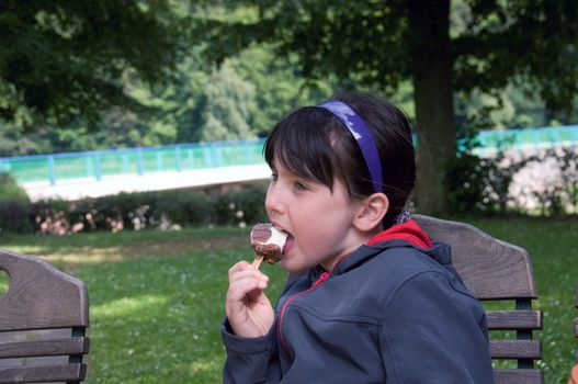 Freckled girl eating ice cream.
