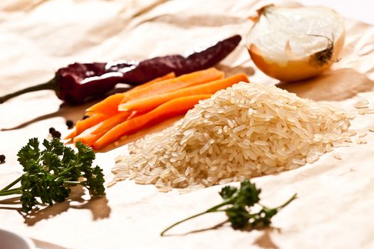 hill of raw rice with vegetables 
and parsley