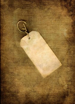 Blank vintage, paper tag on linen in grunge.