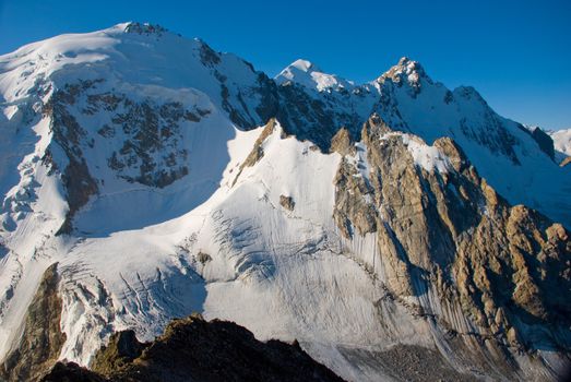 Winter mountains peaks with ice and snow