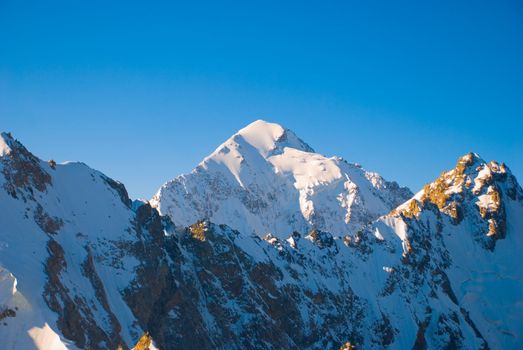 Winter mountains peaks with ice and snow