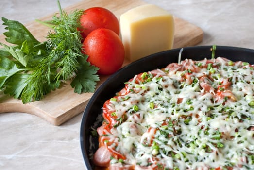 Pizza prepared from the test, a ham, vegetables and cheese