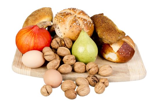 gem, nuts, eggs and a pine on a wooden board. isolated on white background