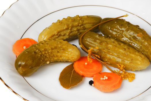 cucumber gherkins with carrots on white plate