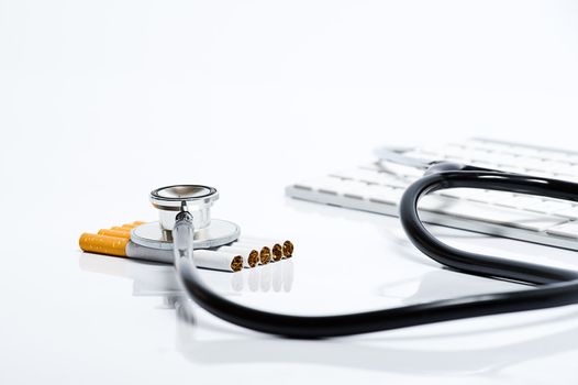 Examination of the dangers of smoking cigarettes on a white background