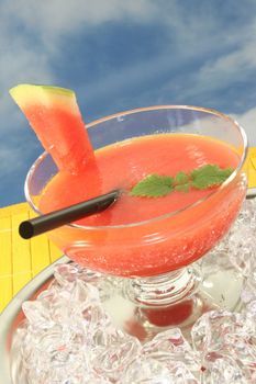 a glass of melon smoothie with fresh lemon balm