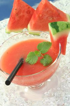 a glass of melon smoothie with fresh lemon balm