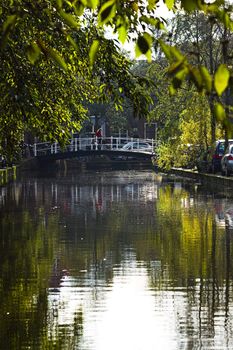 View to old canal and bridge in Dutch city in summer